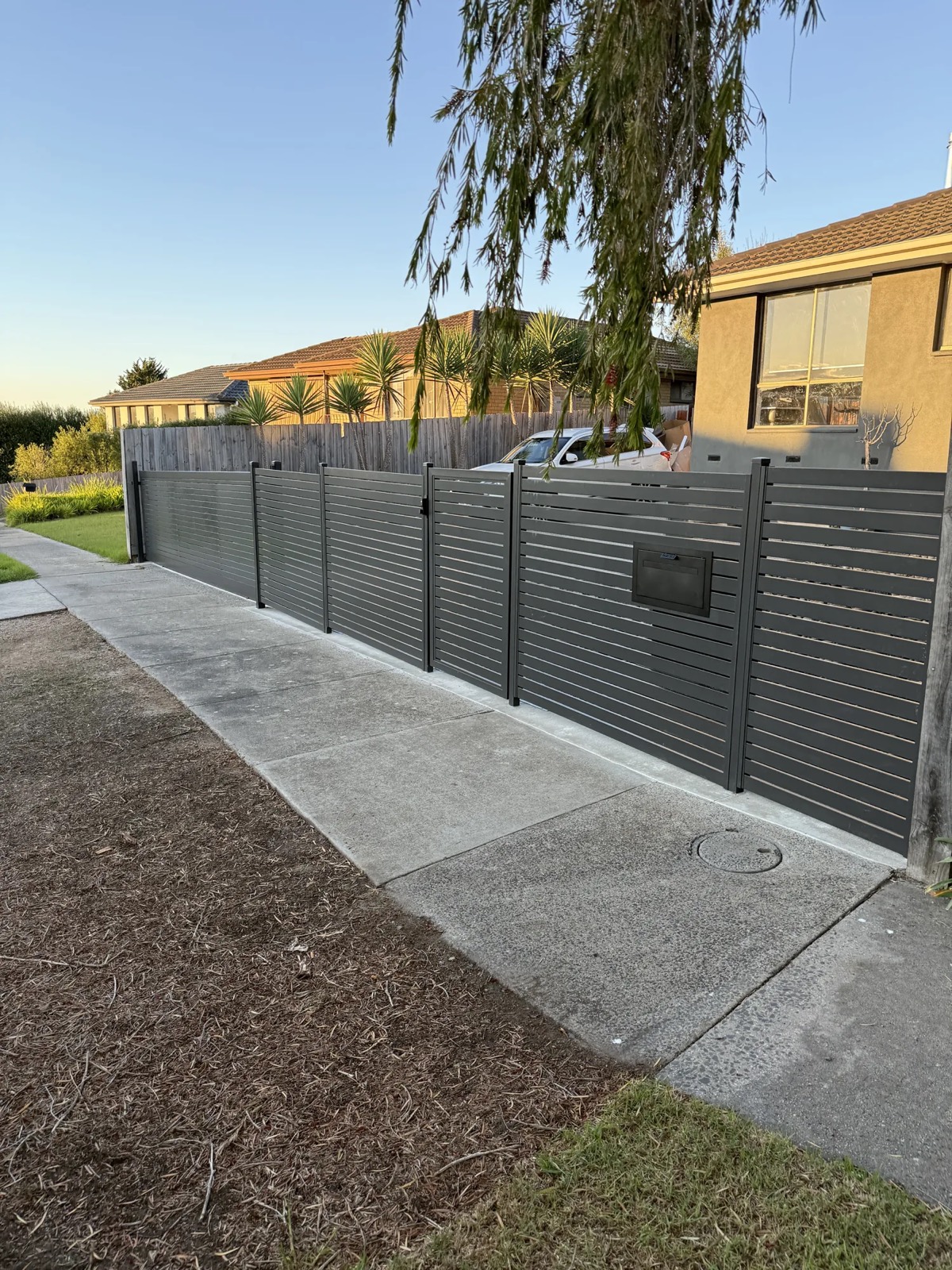 Aluminium slat fence and driveway
