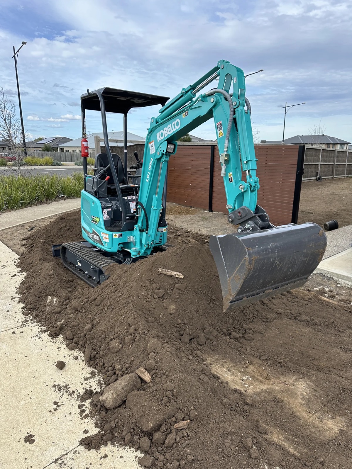 Mini excavator carrying out tight access earthworks