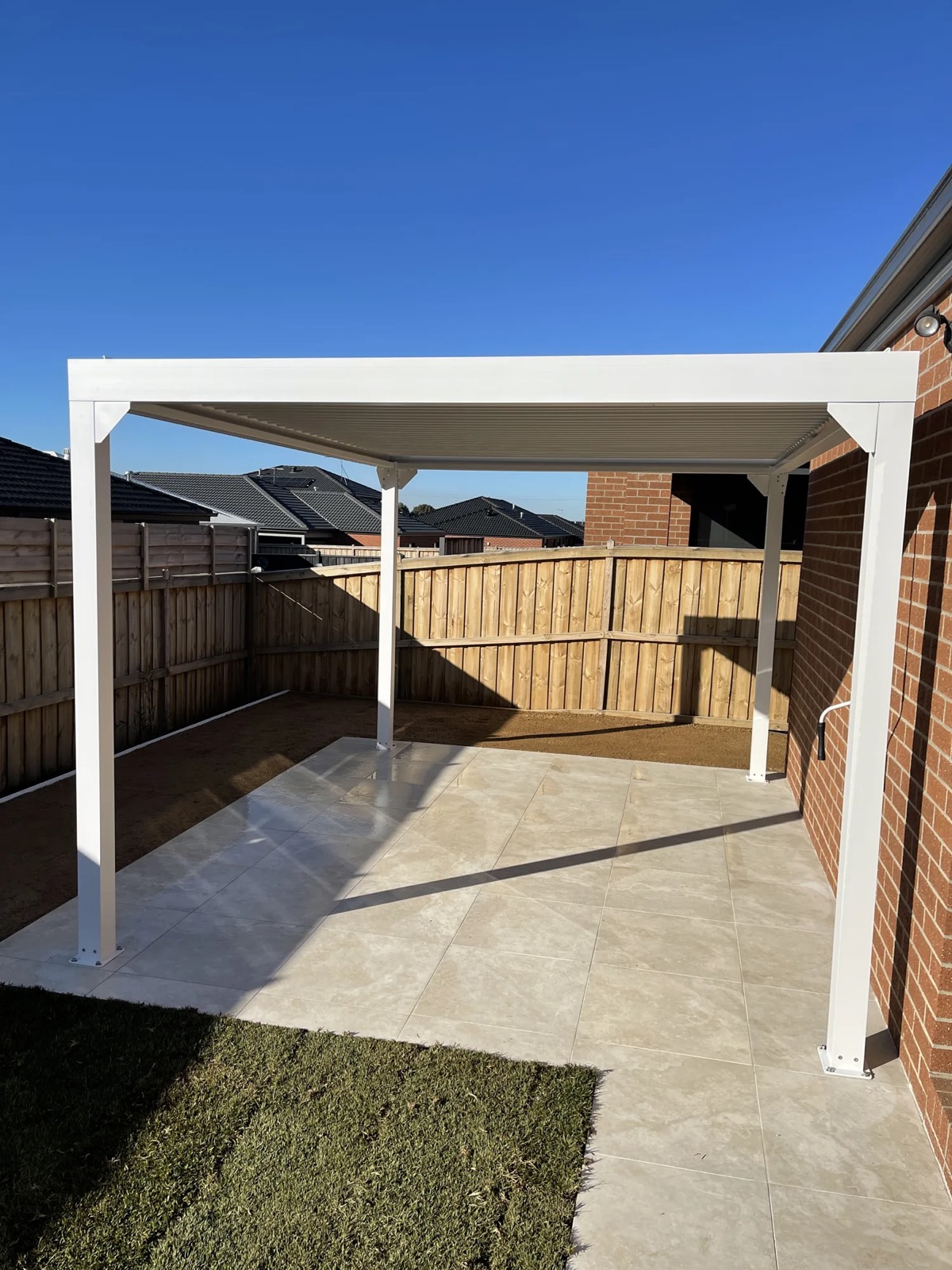 White pergola over concrete patio